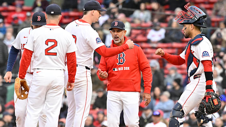 Boston Red Sox starting pitcher Walker Buehler (0) fist bumps catcher Carlos Narvaez (75) as manager Alex Cora (13) comes out to relieve him of the ball during the seventh inning against the Toronto Blue Jays at Fenway Park.