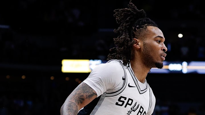 Apr 2, 2025; Denver, Colorado, USA; San Antonio Spurs guard Stephon Castle (5) controls the ball in the first quarter against the Denver Nuggets at Ball Arena.