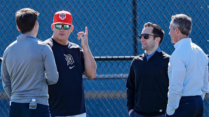 Detroit Tigers chairman and CEO Chris Ilitch, right, talks to president of baseball operations Scott Harris, left, manager A.J. Hinch, center left and general manager Jeff Greenberg during spring training at TigerTown in Lakeland, Fla. on Tuesday, Feb. 20, 2024.