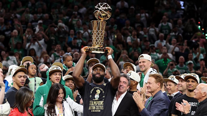 Jun 17, 2024; Boston, Massachusetts, USA; Boston Celtics guard Jaylen Brown (7) holds up the trophy after winning the 2024 NBA Finals against the Dallas Mavericks at TD Garden. Mandatory Credit: Peter Casey-Imagn Images