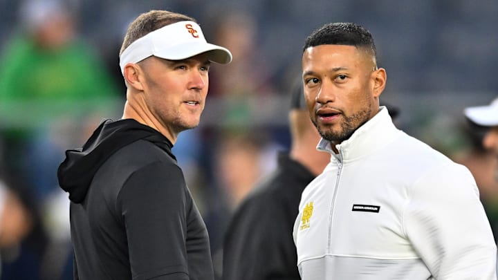 Oct 14, 2023; South Bend, Indiana, USA; USC Trojans head coach Lincoln Riley and Notre Dame Fighting Irish head coach Marcus Freeman chat before the game at Notre Dame Stadium. Oct 14, 2023; South Bend, Indiana, USA; USC Trojans head coach Lincoln Riley and Notre Dame Fighting Irish head coach Marcus Freeman chat before the game at Notre Dame Stadium.