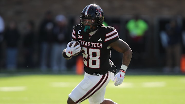 Nov 30, 2024; Lubbock, Texas, USA; Texas Tech Red Raiders running back Tahj Brooks (28) carries the ball against the West Virginia Mountaineers in the first half at Jones AT&T Stadium and Cody Campbell Field. Mandatory Credit: Michael C. Johnson-Imagn Images Nov 30, 2024; Lubbock, Texas, USA; Texas Tech Red Raiders running back Tahj Brooks (28) carries the ball against the West Virginia Mountaineers in the first half at Jones AT&T Stadium and Cody Campbell Field. Mandatory Credit: Michael C. Johnson-Imagn Images