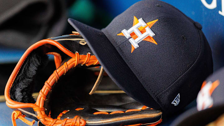 Apr 27, 2025; Kansas City, Missouri, USA; Houston Astros hat and glove in the dugout during the second inning against the Kansas City Royals at Kauffman Stadium. 