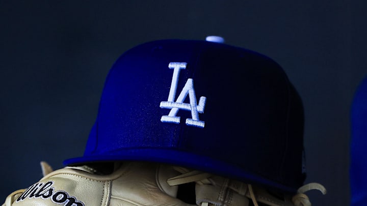 Jul 30, 2025; Cincinnati, Ohio, USA; A general view of a Los Angeles Dodgers hat and glove during the second inning in the game against the Cincinnati Reds at Great American Ball Park.