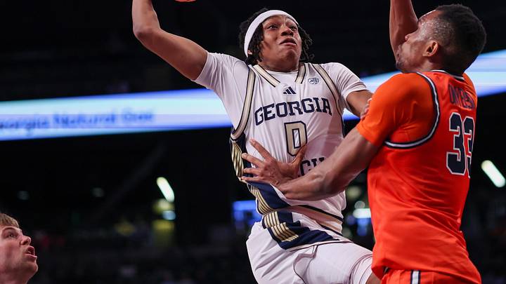 Feb 18, 2026; Atlanta, Georgia, USA; Georgia Tech Yellow Jackets guard Akai Fleming (0) shoots over Virginia Cavaliers center Ugonna Onyenso (33) in the second half at McCamish Pavilion. Mandatory Credit: Brett Davis-Imagn Images
