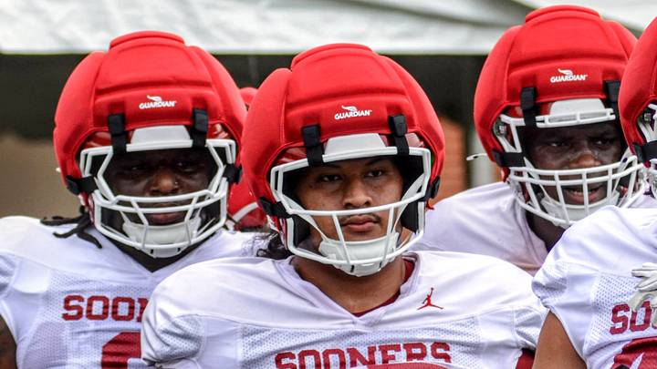 Oklahoma defensive linemen David Stone and Jayden Jackson look on during a drill at practice.