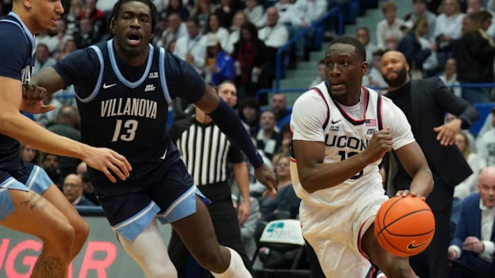 Feb 18, 2025; Hartford, Connecticut, USA; UConn Huskies guard Hassan Diarra (10) drives the ball against Villanova Wildcats forward Enoch Boakye (13) in the first half at XL Center. Mandatory Credit: David Butler II-Imagn Images