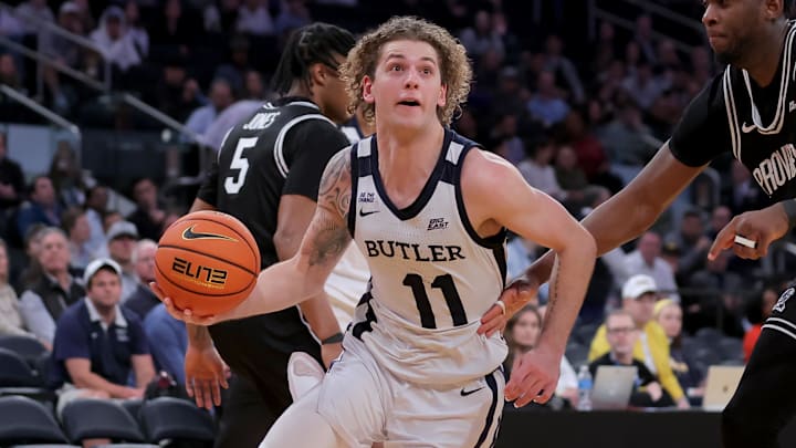 Mar 11, 2026; New York, NY, USA; Butler Bulldogs guard Finley Bizjack (11) drives to the basket against Providence Friars forward Oswin Erhunmwunse (55) during the second half at Madison Square Garden. Mandatory Credit: Brad Penner-Imagn Images