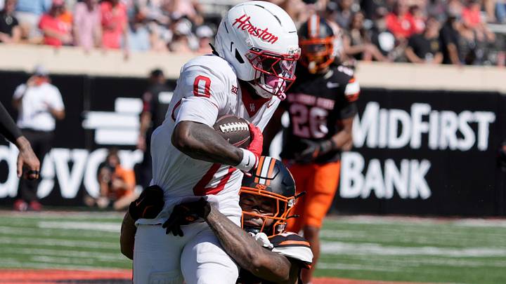 Oklahoma State Cowboys safety Kenneth Harris (23) brings down Houston Cougars wide receiver Amare Thomas (0) during a college football game between the Oklahoma State Cowboys (OSU) and the Houston Cougars at Boone Pickens Stadium in Stillwater, Okla., Saturday, Oct. 11, 2025. Houston won 39-17. Oklahoma State Cowboys safety Kenneth Harris (23) brings down Houston Cougars wide receiver Amare Thomas (0) during a college football game between the Oklahoma State Cowboys (OSU) and the Houston Cougars at Boone Pickens Stadium in Stillwater, Okla., Saturday, Oct. 11, 2025. Houston won 39-17.