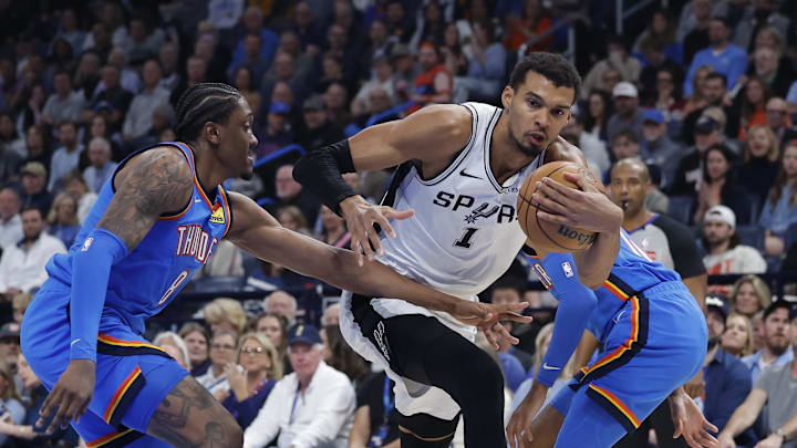 Jan 13, 2026; Oklahoma City, Oklahoma, USA; San Antonio Spurs forward/center Victor Wembanyama (1) drives to the basket beside Oklahoma City Thunder guard/forward Jalen Williams (8) during the second quarter at Paycom Center. Mandatory Credit: Alonzo Adams-Imagn Images