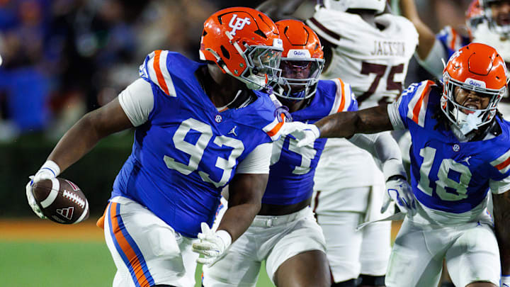 Florida Gators defensive tackle Michai Boireau (93) celebrates with safety Bryce Thornton (18) after an interception during the second half at Ben Hill Griffin Stadium.