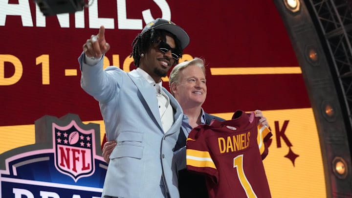 Apr 25, 2024; Detroit, MI, USA; LSU Tigers quarterback Jayden Daniels poses with NFL commissioner Roger Goodell after being selected by the Washington Commanders as the No. 2 pick in the first round of the 2024 NFL Draft at Campus Martius Park and Hart Plaza. Mandatory Credit: Kirby Lee-Imagn Images
