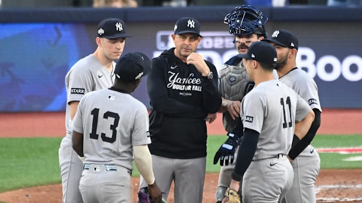 Oct 4, 2025; Toronto, Ontario, CAN; New York Yankees manager Aaron Boone (17) talks to players in the seventh inning against the Toronto Blue Jays during game one of the ALDS round for the 2025 MLB playoffs at Rogers Centre. Mandatory Credit: Dan Hamilton-Imagn Images