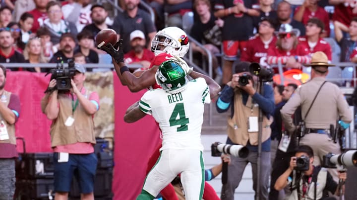 Cardinals wide receiver Marvin Harrison Jr. (18) catches a touchdown pass against Jets cornerback D.J. Reed (4) 