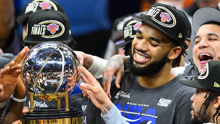 New York Knicks center Karl-Anthony Towns (32) lifts the 2026 Eastern Conference trophy after defeating the Cleveland Cavaliers in game four of the eastern conference finals for the 2026 NBA playoffs at Rocket Arena. 