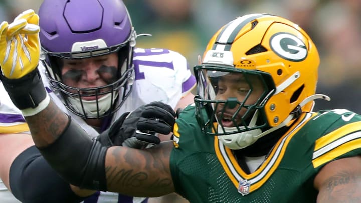 Green Bay Packers defensive end Micah Parsons (1) goes against Minnesota Vikings center Ryan Kelly.