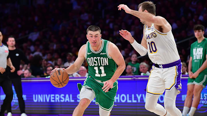 Feb 22, 2026; Los Angeles, California, USA; Boston Celtics guard Payton Pritchard (11) controls the ball against Los Angeles Lakers guard Luke Kennard (10) during the first half at Crypto.com Arena. Mandatory Credit: Gary A. Vasquez-Imagn Images