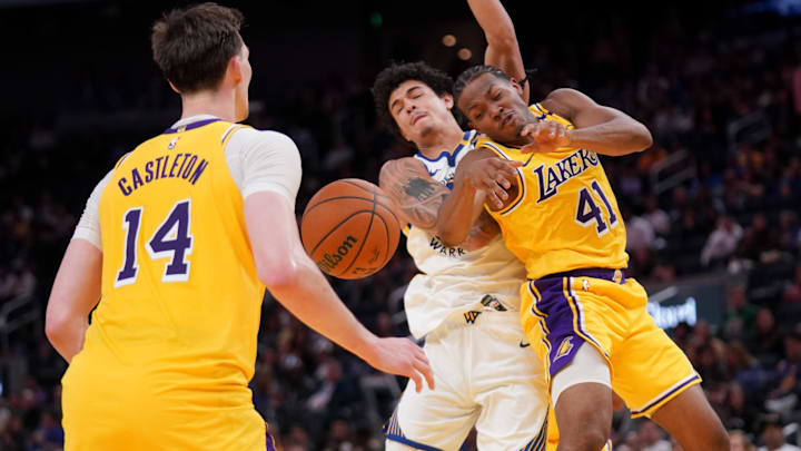 Former Los Angeles Lakers guard Quincy Olivari (41) is unable to control a rebound in front of Golden State Warriors forward Gui Santos (15) in the fourth quarter at the Chase Center.