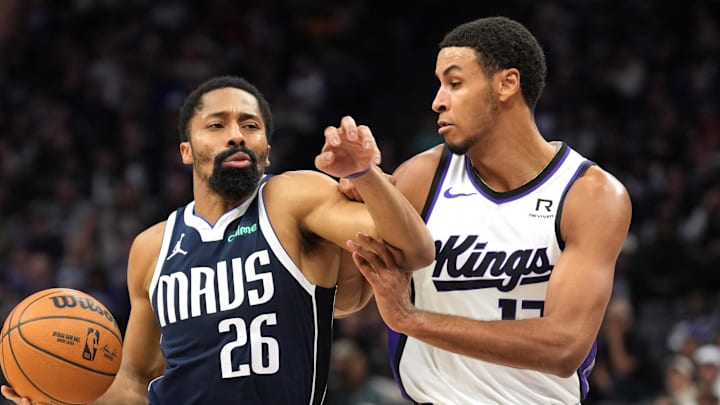 Dec 30, 2024; Sacramento, California, USA; Dallas Mavericks guard Spencer Dinwiddie (26) drives against Sacramento Kings forward Keegan Murray (right) during the second quarter at Golden 1 Center. Mandatory Credit: Darren Yamashita-Imagn Images