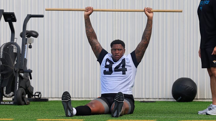 Jacksonville Jaguars defensive tackle Maason Smith (94) works out as Eric Ciano, Director of strength and conditioning, looks on during an NFL training camp session at the Miller Electric Center, Friday, July 25, 2025, in Jacksonville, Fla. [Corey Perrine/Florida Times-Union]