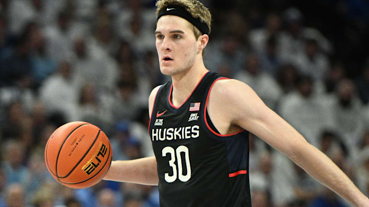 Feb 11, 2025; Omaha, Nebraska, USA;  Connecticut Huskies forward Liam McNeeley (30) dribbles against the Creighton Bluejays during the first half at CHI Health Center Omaha. Mandatory Credit: Steven Branscombe-Imagn Images