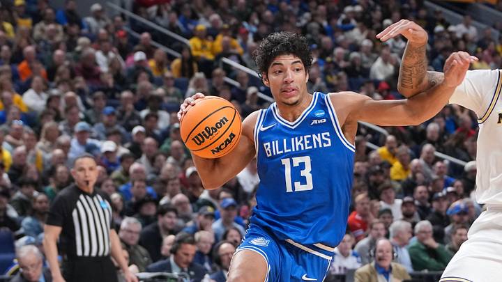 Mar 21, 2026; Buffalo, NY, USA; Saint Louis Billikens guard Dion Brown (13) drives the ball while defended by Michigan Wolverines guard Roddy Gayle Jr. (11) in the second half during a second-round game of the men's 2026 NCAA Tournament at KeyBank Center. Mandatory Credit: Gregory Fisher-Imagn Images