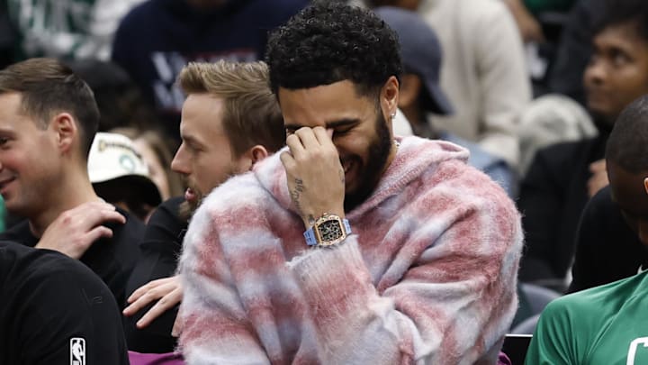 Dec 4, 2025; Washington, District of Columbia, USA; Injured Boston Celtics forward Jayson Tatum (L) reacts on the bench against the Washington Wizards in the second half at Capital One Arena. Mandatory Credit: Geoff Burke-Imagn Images