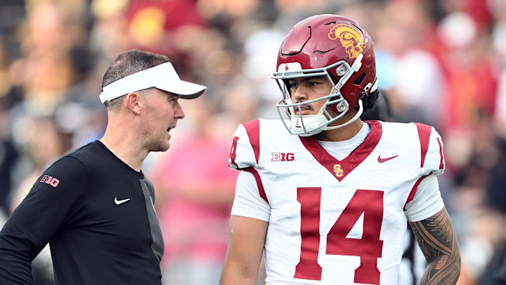 Sep 13, 2025; West Lafayette, Indiana, USA;  Southern California Trojans quarterback Jayden Maiava (14) talks with Southern California Trojans head coach Lincoln Riley  before the game against the Purdue Boilermakers at Ross-Ade Stadium. Mandatory Credit: Marc Lebryk-Imagn Images
