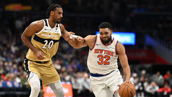 Feb 3, 2026; Washington, District of Columbia, USA; New York Knicks center Karl-Anthony Towns (32) dribbles the ball in front of Washington Wizards center Alex Sarr (20) during the third quarter at Capital One Arena. Mandatory Credit: Rafael Suanes-Imagn Images