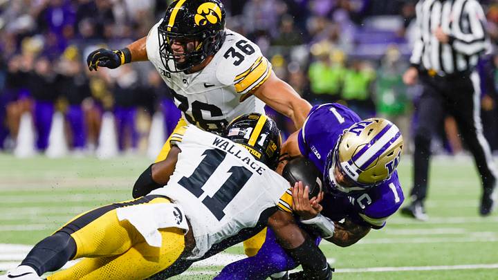 Oct 9, 2026; Seattle, Washington, USA; Iowa Hawkeyes defensive back Jacob Wallace (11) and linebacker Jayden Montgomery (36) tackle Washington Huskies quarterback Demond Williams Jr. (1) during the second quarter at Husky Stadium. Mandatory Credit: Joe Nicholson-Imagn Images Oct 9, 2026; Seattle, Washington, USA; Iowa Hawkeyes defensive back Jacob Wallace (11) and linebacker Jayden Montgomery (36) tackle Washington Huskies quarterback Demond Williams Jr. (1) during the second quarter at Husky Stadium. Mandatory Credit: Joe Nicholson-Imagn Images