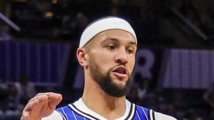 Milwaukee Bucks guard Ryan Rollins handles the ball in front of Orlando Magic guard Jalen Suggs.