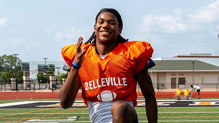 Senior Elijah Dotson, left, participates in a drill alongside Bryce Underwood during a team practice at Belleville High School football field in Belleville on Wednesday, Aug. 14, 2024.
