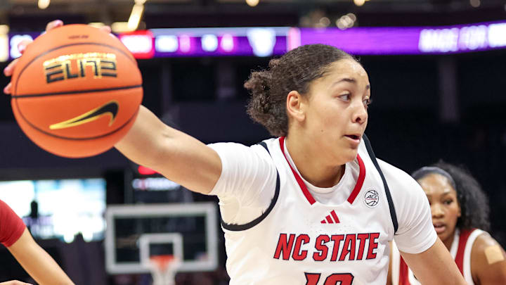 Nov 9, 2025; Charlotte, North Carolina, USA; NC State Wolfpack forward Khamil Pierre (12) controls the ball against the Southern California Trojans during the second quarter of the Ally Tipoff game at Spectrum Center. Mandatory Credit: Cory Knowlton-Imagn Images
