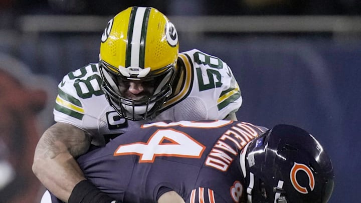 Green Bay Packers linebacker Isaiah McDuffie (58) tackles Chicago Bears tight end Colston Loveland.