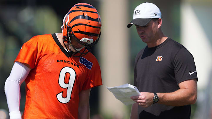 Jul 25, 2025; Cincinnati, OH, USA; Cincinnati Bengals quarterback Joe Burrow (9), left, talks with head coach Zac Taylor, right, during training camp practice. Mandatory Credit: Kareem Elgazzar-Imagn Images