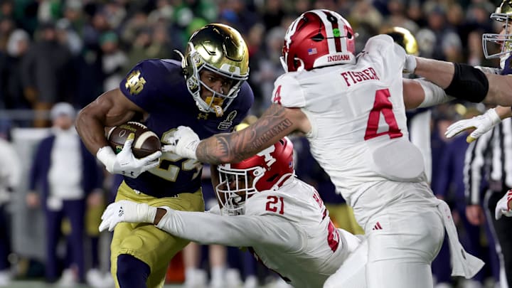 Notre Dame running back Jadarian Price (24) tackled by Indiana linebackers Rolijah Hardy (21) Aiden Fisher (4) at Notre Dame Stadium. Notre Dame running back Jadarian Price (24) tackled by Indiana linebackers Rolijah Hardy (21) Aiden Fisher (4) at Notre Dame Stadium.
