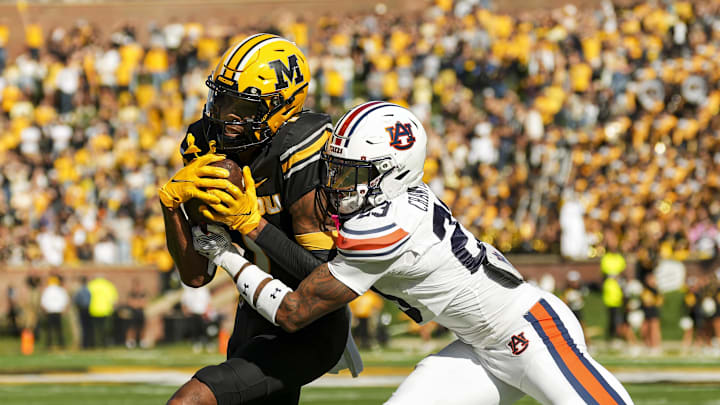 Oct 19, 2024; Columbia, Missouri, USA; Missouri Tigers wide receiver Theo Wease Jr. (1) runs with the ball against Auburn Tigers cornerback Jay Crawford (23) during the second half at Faurot Field at Memorial Stadium. Mandatory Credit: Jay Biggerstaff-Imagn Images