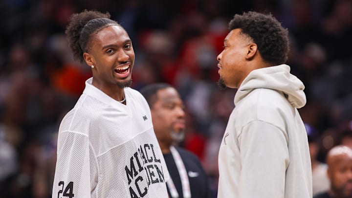 Mar 23, 2025; Atlanta, Georgia, USA; Philadelphia 76ers guard Tyrese Maxey (0) talks to guard Kyle Lowry (7) during a timeout against the Atlanta Hawks in the second quarter at State Farm Arena. Mandatory Credit: Brett Davis-Imagn Images