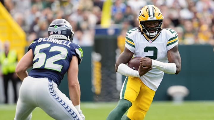 Aug 23, 2025; Green Bay, Wisconsin, USA; Green Bay Packers quarterback Malik Willis (2) rushes with the football between Seattle Seahawks linebacker Patrick O'Connell (52) and outside linebacker Jamie Sheriff (50) during the first quarter at Lambeau Field.