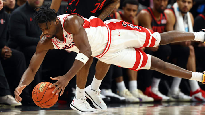 Dec 20, 2025; Phoenix, Arizona, USA; Arizona Wildcats forward Dwayne Aristode (2) dives for a loose ball against San Diego State Aztecs guard Taj DeGourville (24) in the second half during the Hall of Fame Series at Mortgage Matchup Center. Mandatory Credit: Mark J. Rebilas-Imagn Images