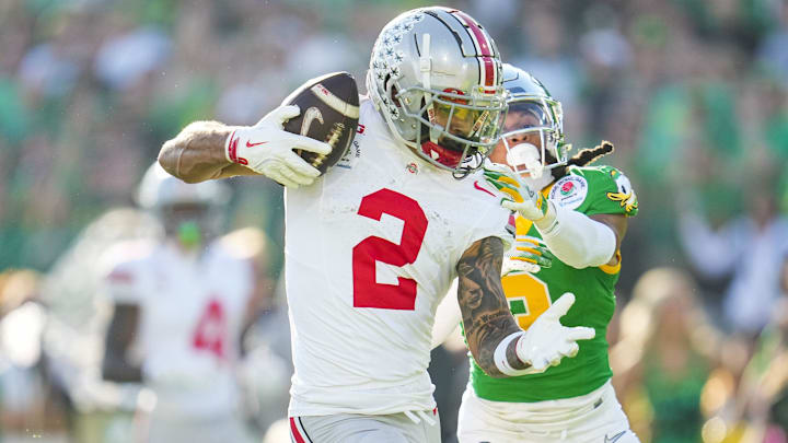 Ohio State Buckeyes wide receiver Emeka Egbuka (2) catches a touchdown in front of Oregon Ducks defensive back Brandon Johnson (3) during the first half of the College Football Playoff quarterfinal at the Rose Bowl in Pasadena, Calif. on Jan. 1, 2025.