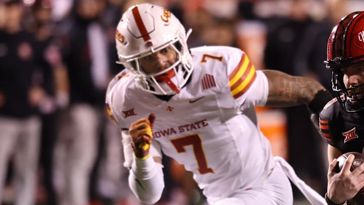 Nov 23, 2024; Salt Lake City, Utah, USA; Utah Utes quarterback Luke Bottari (15) runs the ball against Iowa State Cyclones defensive back Malik Verdon (7) during the fourth quarter at Rice-Eccles Stadium. Mandatory Credit: Rob Gray-Imagn Images