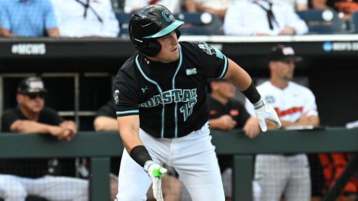 Jun 15, 2025; Omaha, Neb, USA; Coastal Carolina Chanticleers catcher Caden Bodine (17) reaches on an infield error by the Oregon State Beavers during the first inning at Charles Schwab Field. Jun 15, 2025; Omaha, Neb, USA; Coastal Carolina Chanticleers catcher Caden Bodine (17) reaches on an infield error by the Oregon State Beavers during the first inning at Charles Schwab Field.