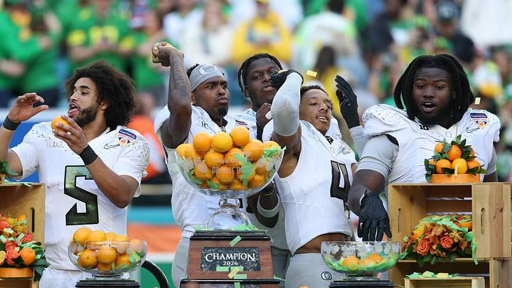 Jan 1, 2026; Miami Gardens, FL, USA; Oregon Ducks quarterback Dante Moore (5), wide receiver Malik Benson (4), defensive back Brandon Finney (4) and defensive lineman Bear Alexander (1) celebrate following the 2025 Orange Bowl and quarterfinal game of the College Football Playoff against the Texas Tech Red Raiders at Hard Rock Stadium. Mandatory Credit: Nathan Ray Seebeck-Imagn Images Jan 1, 2026; Miami Gardens, FL, USA; Oregon Ducks quarterback Dante Moore (5), wide receiver Malik Benson (4), defensive back Brandon Finney (4) and defensive lineman Bear Alexander (1) celebrate following the 2025 Orange Bowl and quarterfinal game of the College Football Playoff against the Texas Tech Red Raiders at Hard Rock Stadium. Mandatory Credit: Nathan Ray Seebeck-Imagn Images