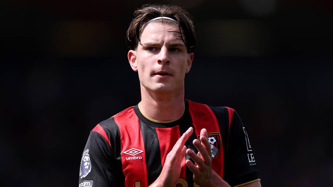 Alex Scott applauds in a Bournemouth home shirt