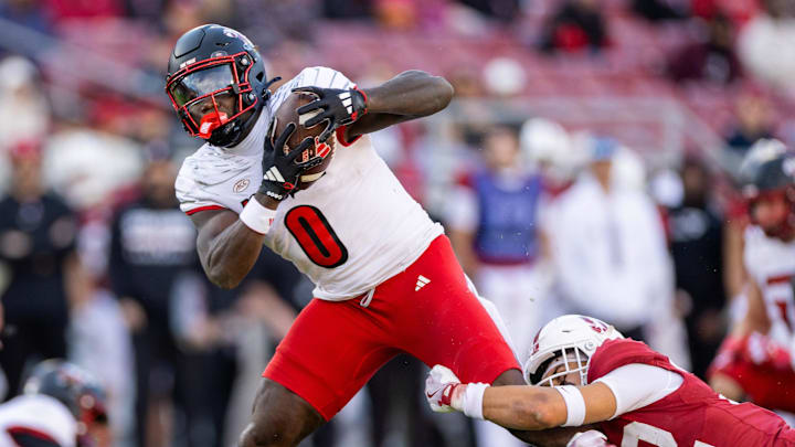 Nov 16, 2024; Stanford, California, USA;  Louisville Cardinals wide receiver Chris Bell (0) is wrapped up against the Stanford Cardinal during the fourth quarter at Stanford Stadium. Mandatory Credit: Bob Kupbens-Imagn Images
