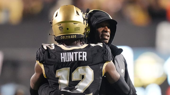 Oct 13, 2023; Boulder, Colorado, USA; Colorado Buffaloes wide receiver Travis Hunter (12) is congratulated for his touchdown by head coach Deion Sanders in the first quarter against the Stanford Cardinal at Folsom Field. Mandatory Credit: Ron Chenoy-Imagn Images