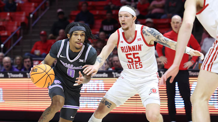 Feb 17, 2025; Salt Lake City, Utah, USA; Kansas State Wildcats guard Dug McDaniel (0) drives against Utah Utes guard Gabe Madsen (55) during the first half at Jon M. Huntsman Center. Mandatory Credit: Rob Gray-Imagn Images