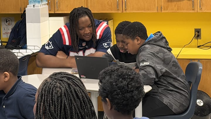 New England Patriots center Jared Wilson learning about AI tools with students at Mattahunt Elementary School.