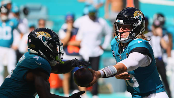 Sep 8, 2024; Miami Gardens, Florida, USA; Jacksonville Jaguars running back Tank Bigsby (4) takes a handoff from quarterback Trevor Lawrence (16) during the fourth quarter at Hard Rock Stadium. Mandatory Credit: Sam Navarro-Imagn Images